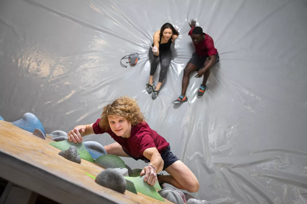 full-shot-man-climbing-wall