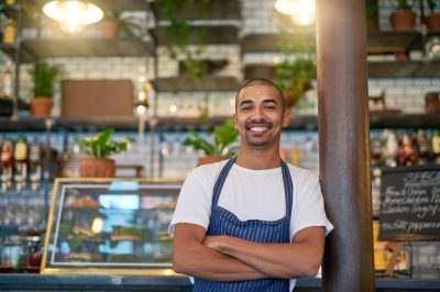 Portrait of a young entrepreneur standing in his business.